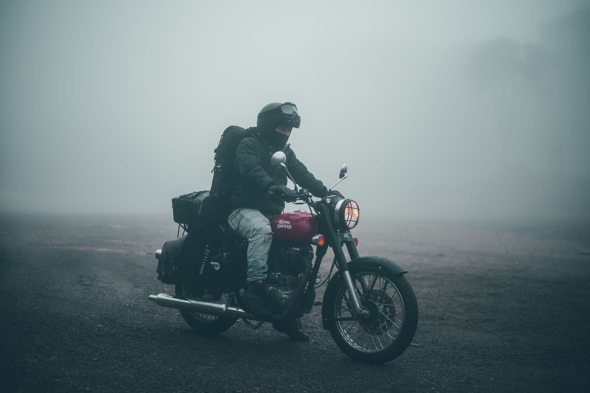 Motociclista circulando por una carretera con niebla en los cerros de Bogotá